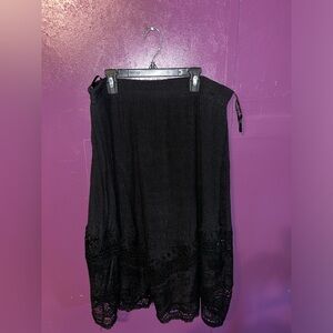 Long black Rebellion skirt with lace-like design.